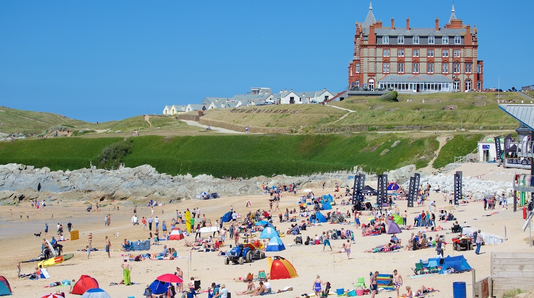 Fistral Beach featuring a beach and a coastal town as well as a large group of people