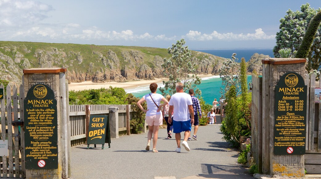 Minack Theatre which includes signage, general coastal views and hiking or walking