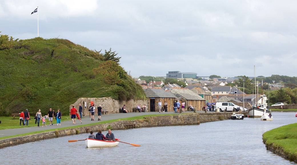 Bude featuring boating and a coastal town as well as a large group of people