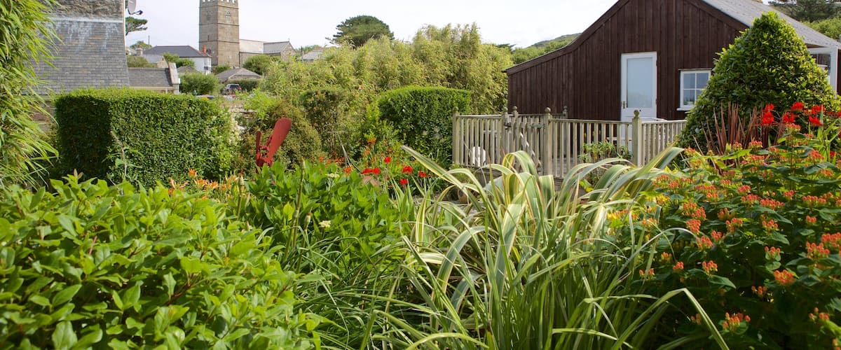 Wayside Museum featuring a coastal town, a house and flowers