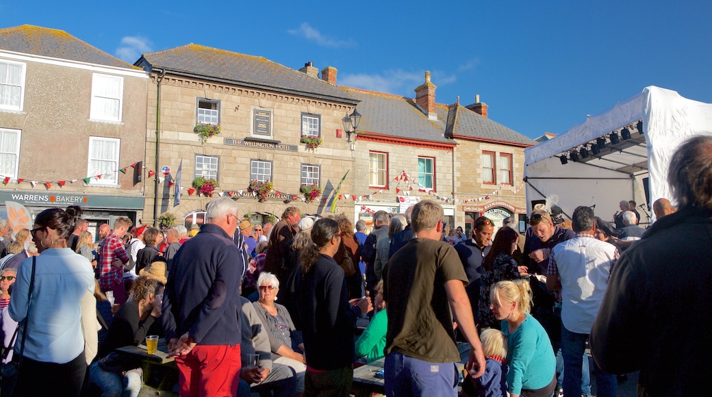 St Just featuring a square or plaza and street scenes as well as a large group of people