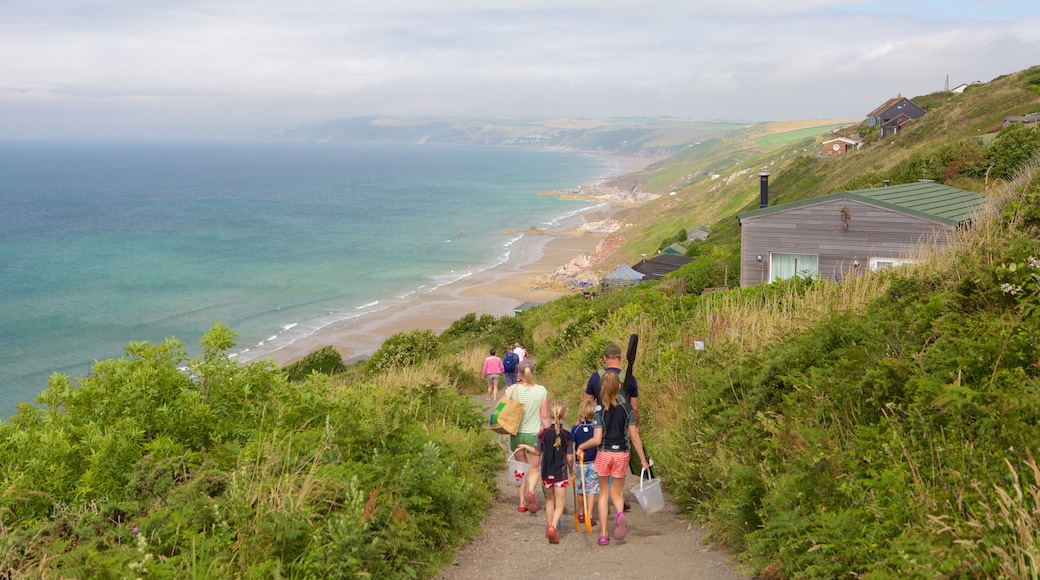 Whitsand Bay Beach featuring a coastal town and a sandy beach as well as a family