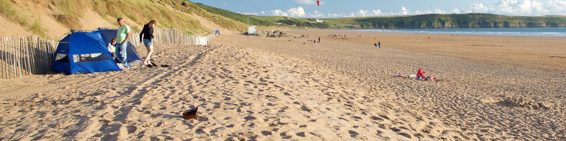 Woolacombe which includes landscape views and a sandy beach as well as a couple