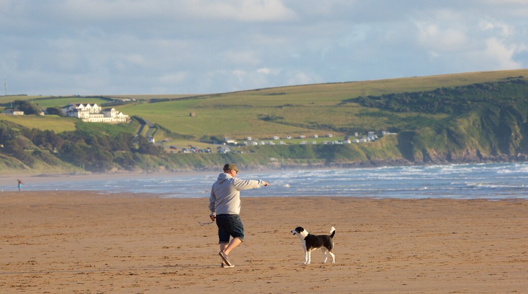 Woolacombe featuring a sandy beach as well as an individual male