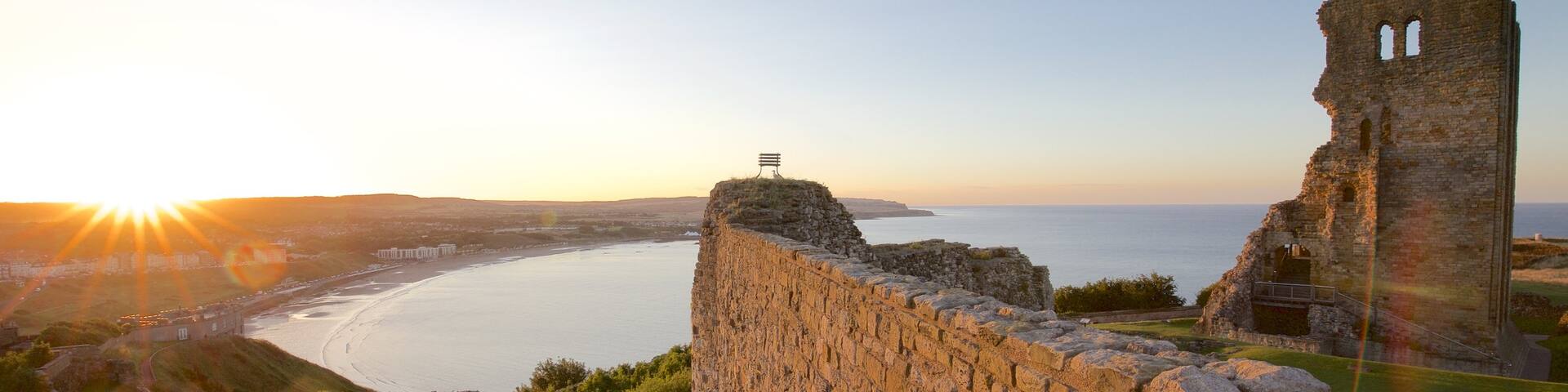 Scarborough Castle which includes a sunset, a castle and heritage elements