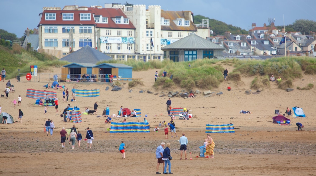 Bude Beach featuring a beach and a coastal town as well as a large group of people