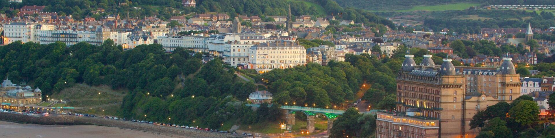 South Bay Beach showing a sandy beach and a coastal town