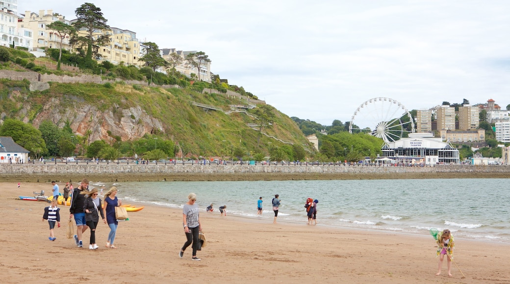 Abbey Sands showing a beach and a coastal town as well as a family