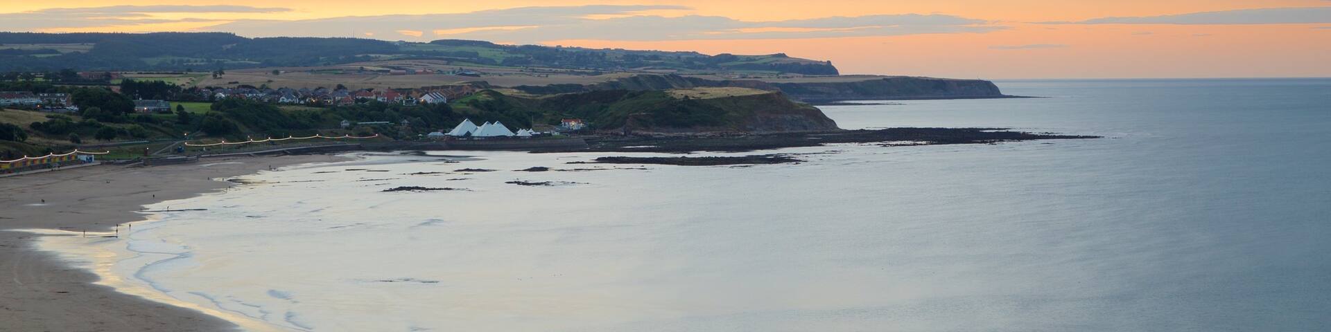 North Bay Beach which includes landscape views, a beach and a sunset
