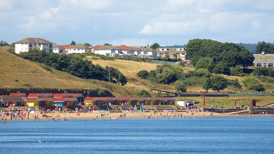 North Bay Beach which includes a coastal town and a sandy beach as well as a large group of people
