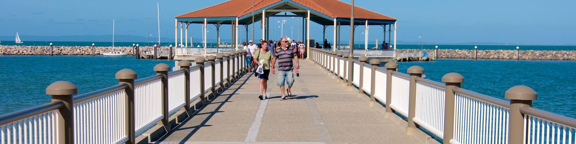 Redcliffe showing general coastal views as well as a small group of people