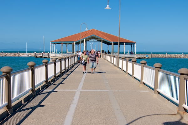 Redcliffe featuring general coastal views as well as a small group of people