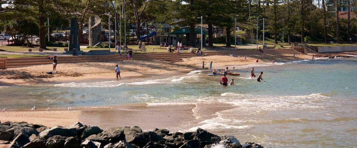Redcliffe featuring a beach and surf as well as a small group of people