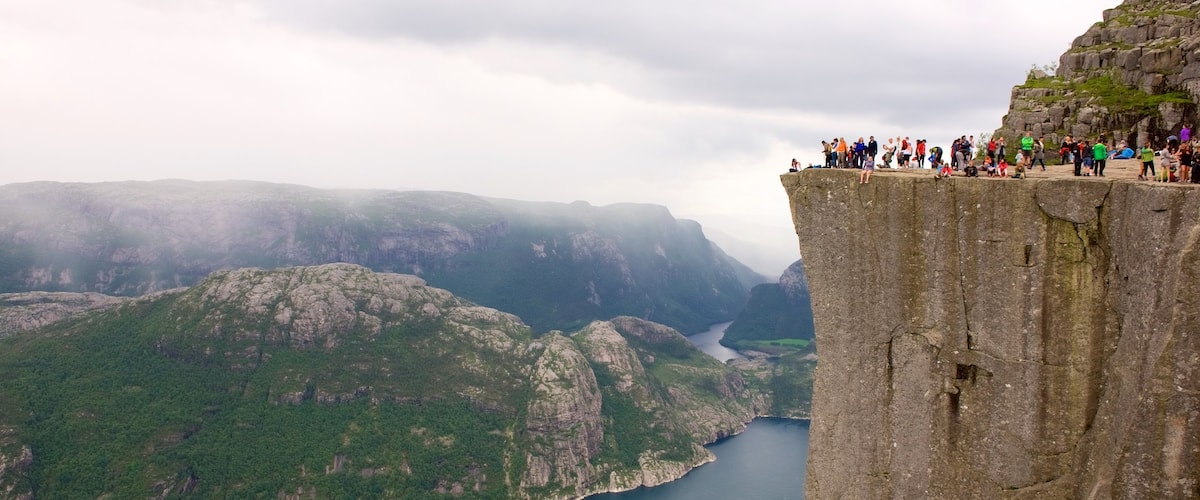 Preikestolen which includes mountains, a lake or waterhole and views