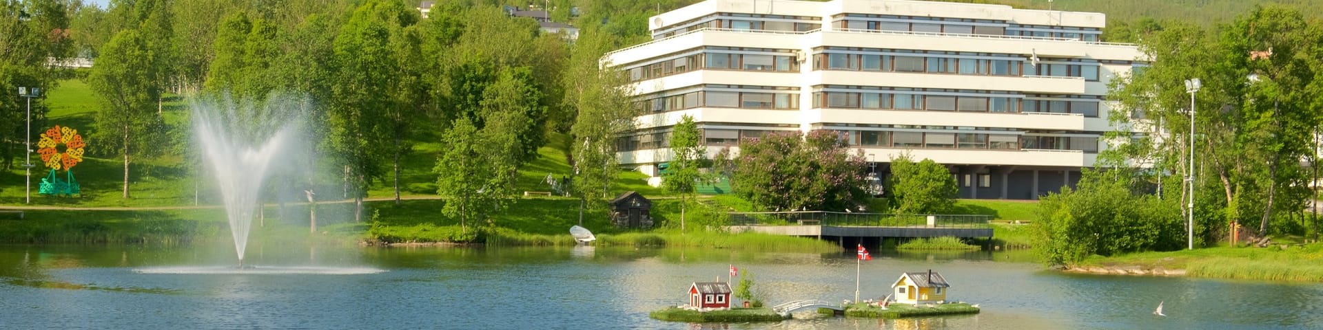 Finnsnes which includes a fountain, a luxury hotel or resort and a lake or waterhole