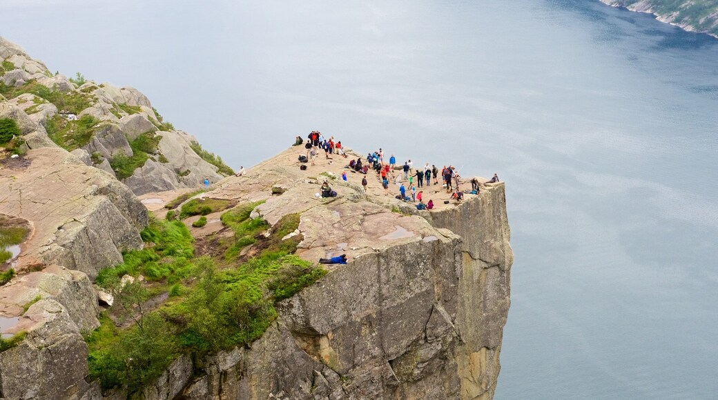 Preikestolen featuring views and a lake or waterhole as well as a large group of people