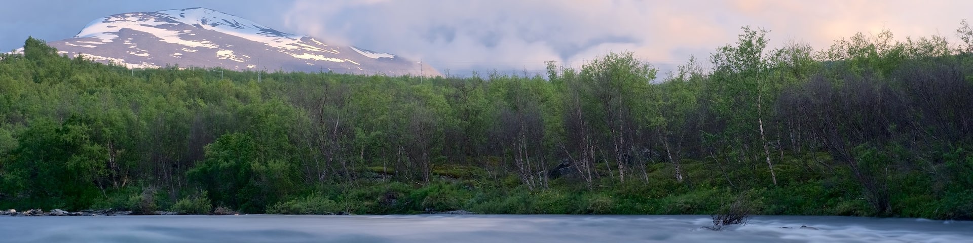 Abisko National Park featuring mist or fog, a sunset and a river or creek
