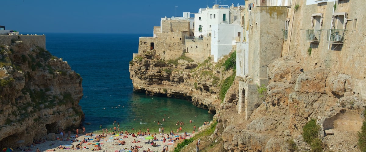 Polignano a Mare featuring rugged coastline, a coastal town and a pebble beach