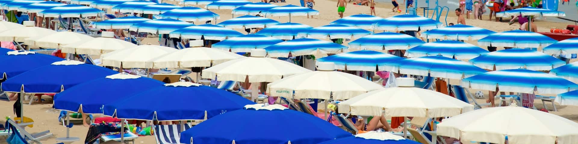 Rodi Garganico showing general coastal views and a sandy beach as well as a large group of people