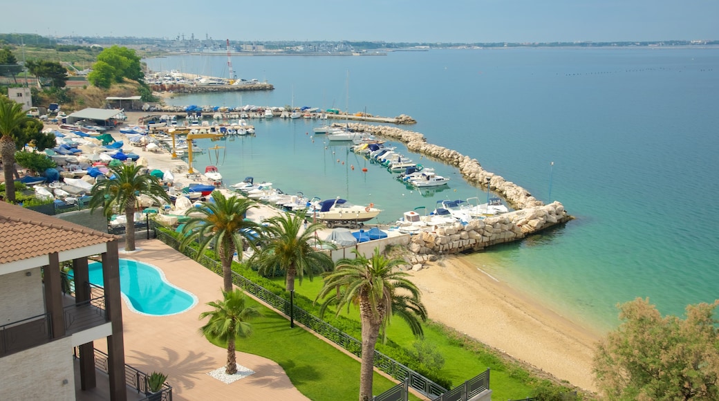 Taranto which includes a coastal town, general coastal views and a sandy beach