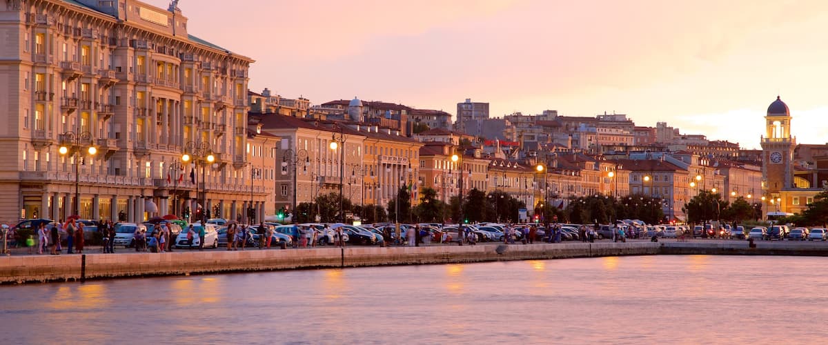 Trieste featuring general coastal views, a sunset and heritage architecture
