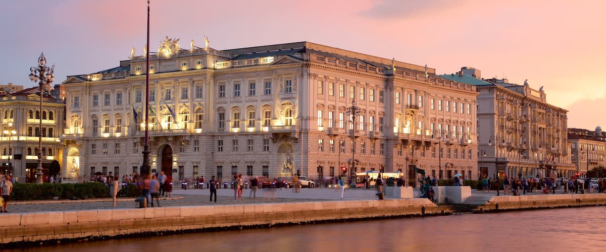 Piazza dell\'Unita featuring heritage architecture, general coastal views and a sunset