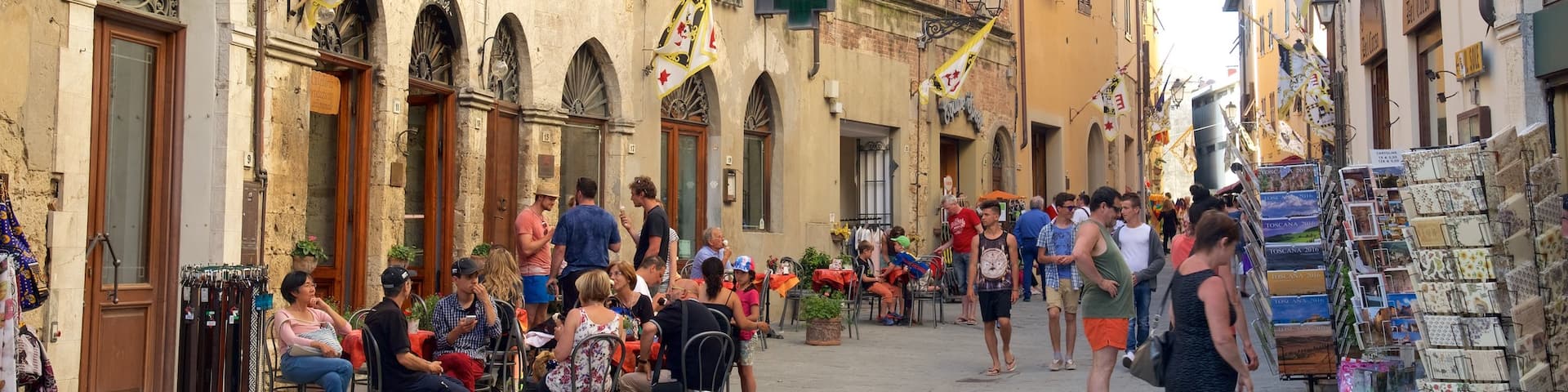 Massa Marittima showing heritage architecture as well as a large group of people