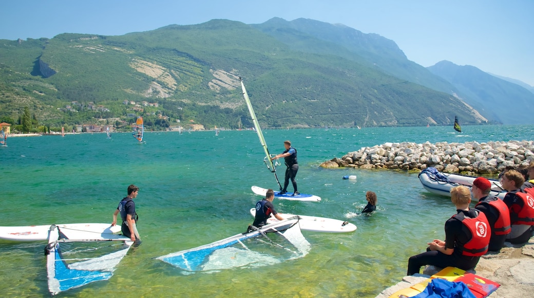 Nago-Torbole which includes rocky coastline and kite surfing as well as a small group of people