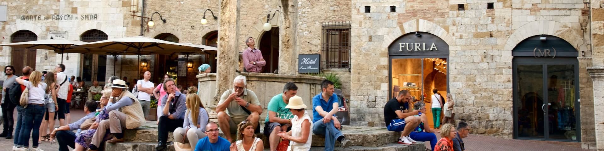 Piazza della Cisterna which includes a city, street scenes and a square or plaza