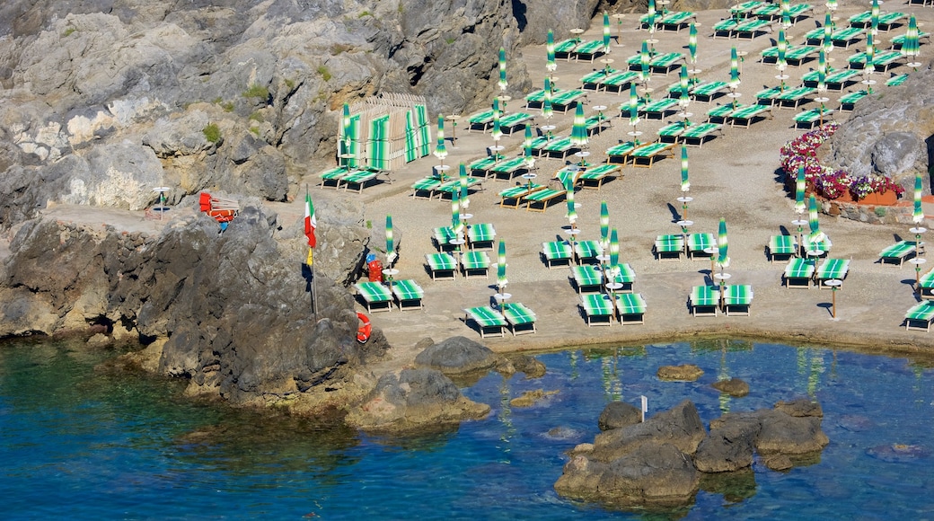 Talamone which includes a coastal town, rocky coastline and general coastal views