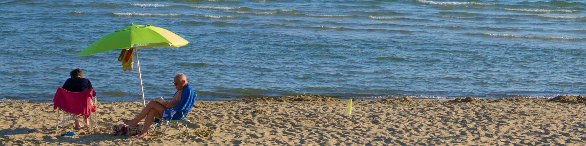 Follonica featuring a beach as well as a couple
