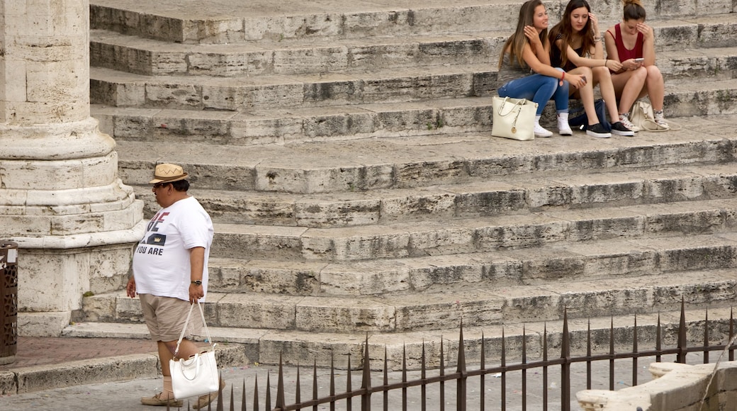 Piazza IV Novembre showing a city as well as a small group of people