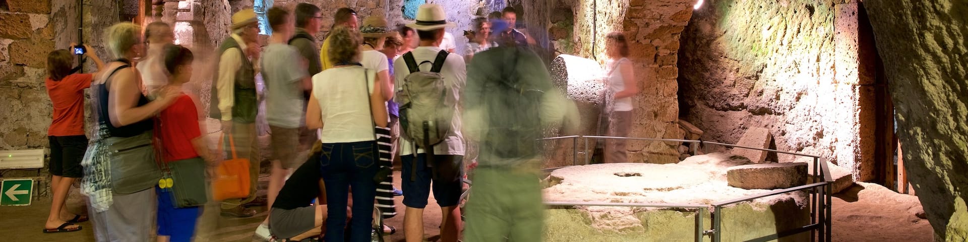 Etruscan Orvieto Underground showing caves and interior views as well as a large group of people