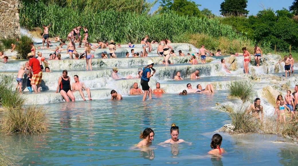 Grosseto which includes a lake or waterhole and swimming as well as a large group of people