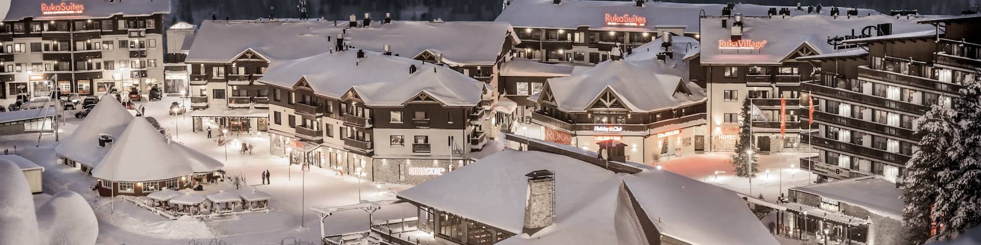 Ruka Ski Area featuring a small town or village, snow and night scenes