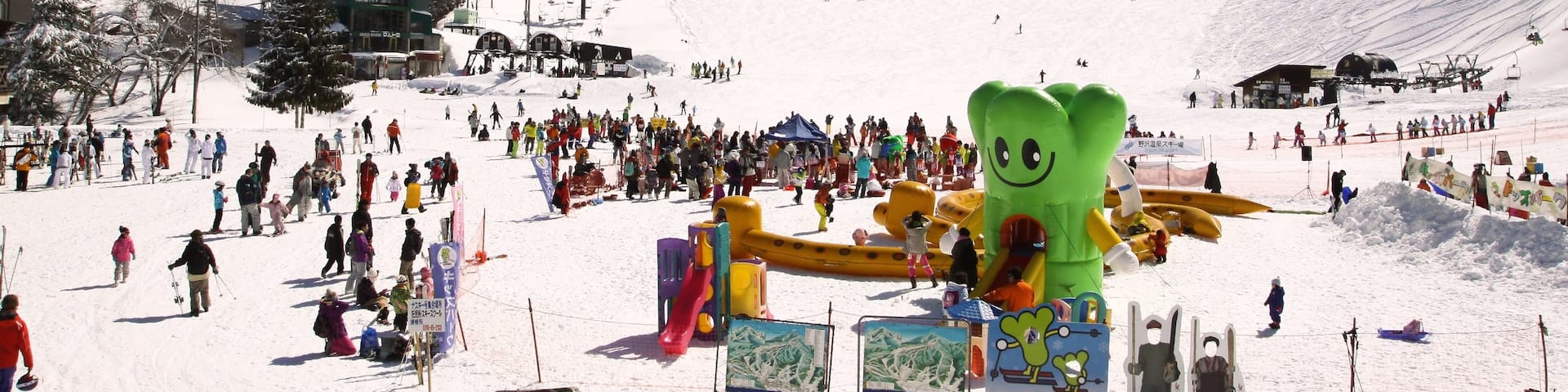 Nozawa Onsen Snow Resort which includes snow and a luxury hotel or resort as well as a large group of people