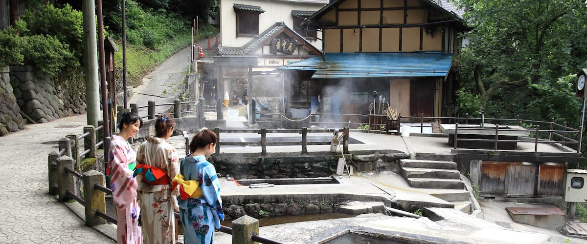 Nozawa Onsen Snow Resort featuring a hot spring and a luxury hotel or resort as well as a small group of people