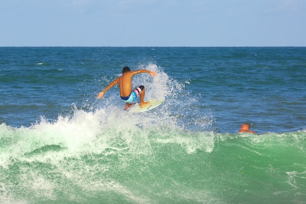 Maracaipe Beach showing surfing and a sandy beach