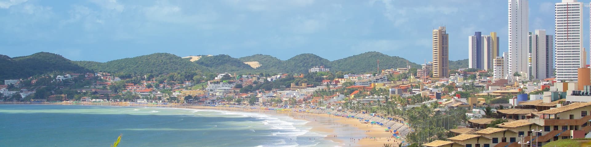 Ponta Negra Beach featuring a beach, a skyscraper and a coastal town