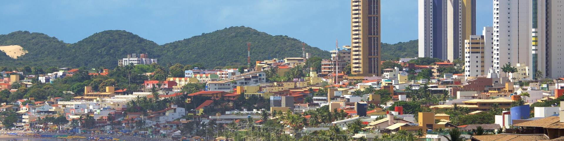 Ponta Negra Beach which includes a coastal town, a skyscraper and a beach