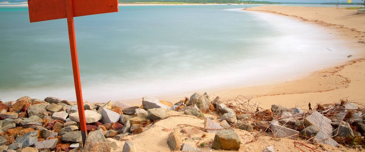 Barra do Cunhau showing rocky coastline, general coastal views and a sandy beach