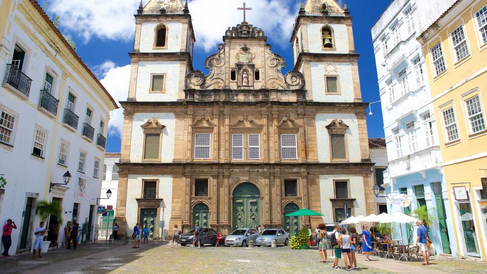 Pelourinho featuring a church or cathedral and street scenes as well as a small group of people