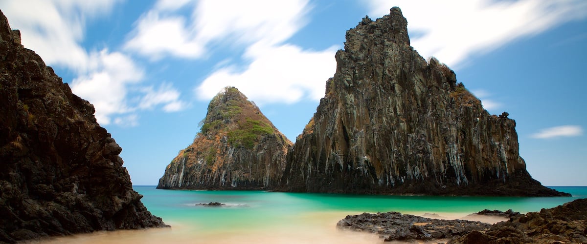 Dois Irmaos Hill which includes general coastal views, rugged coastline and a beach