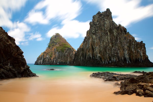 Dois Irmaos Hill which includes general coastal views, rugged coastline and a sandy beach