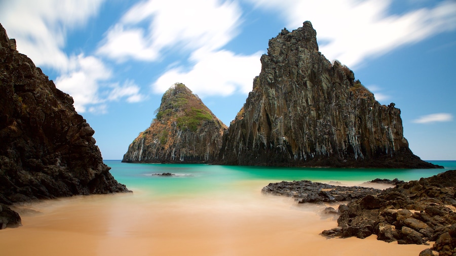 Dois Irmaos Hill which includes general coastal views, rugged coastline and a sandy beach