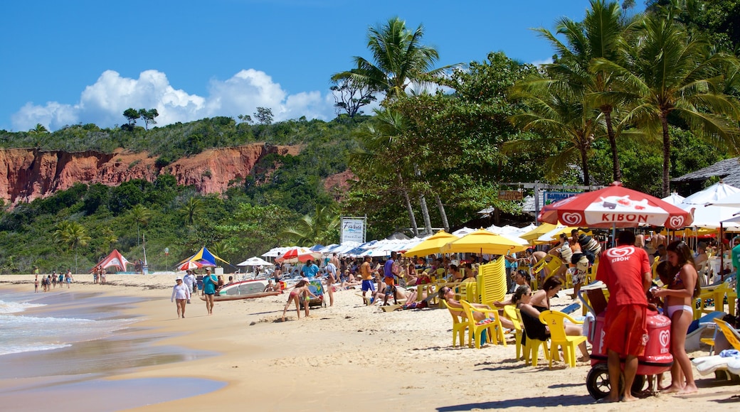 Pitinga Beach which includes a sandy beach, general coastal views and outdoor eating