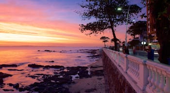 Farol da Barra Beach which includes a sunset, general coastal views and a coastal town