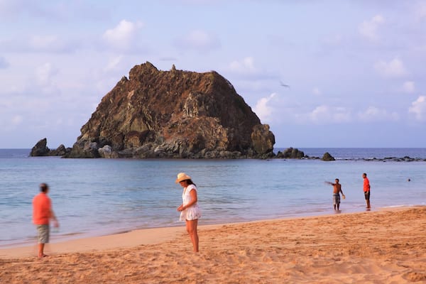 Conceicao Beach which includes general coastal views and a beach as well as a small group of people