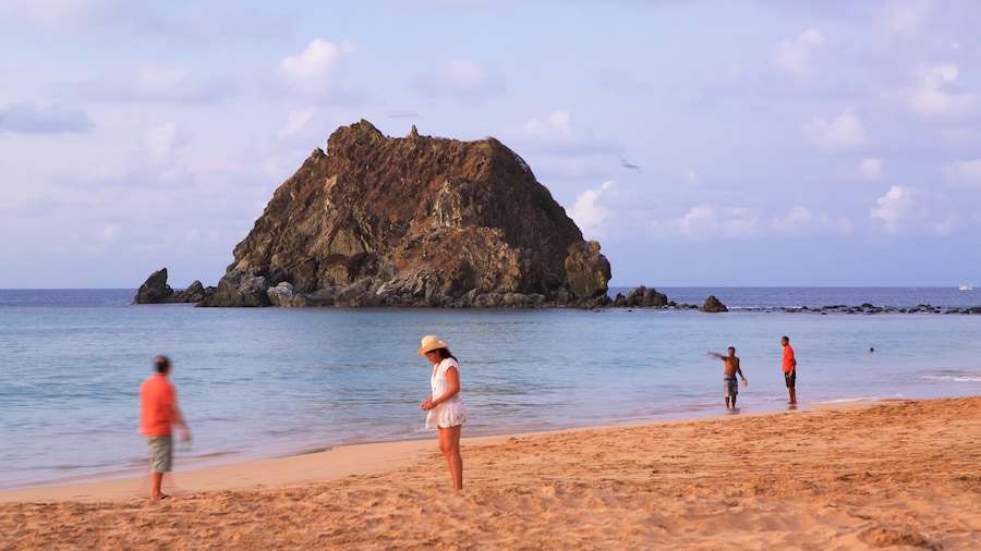 Conceicao Beach which includes general coastal views and a beach as well as a small group of people