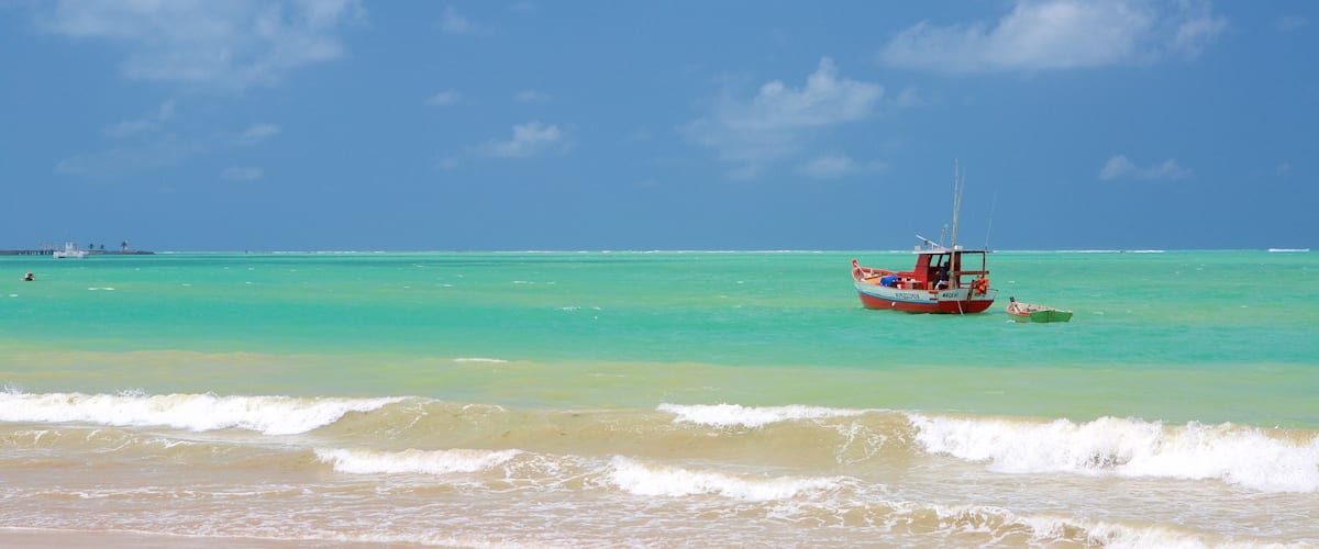 Pajucara Beach showing a sandy beach, boating and general coastal views